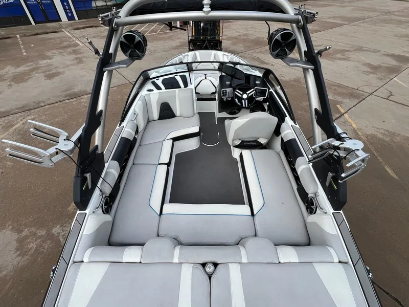 Slide: The Image of 2018 Malibu 21 VLX boat interior with spacious seating and modern dashboard. - 6