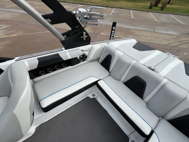 Slide: The Image of 2018 Malibu 21 VLX boat interior with white seating and sleek design. - 8