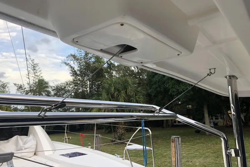 Slide: The Image of 2013 Leopard 39 Owner's Version yacht with stainless steel rigging and lush greenery in the background. - 10