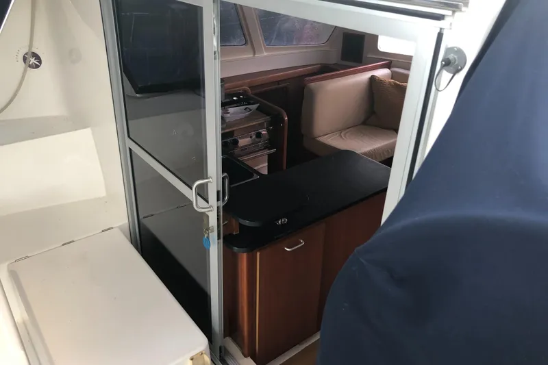 Slide: The Image of 2013 Leopard 39 Owner's Version interior with seating and kitchenette. - 11