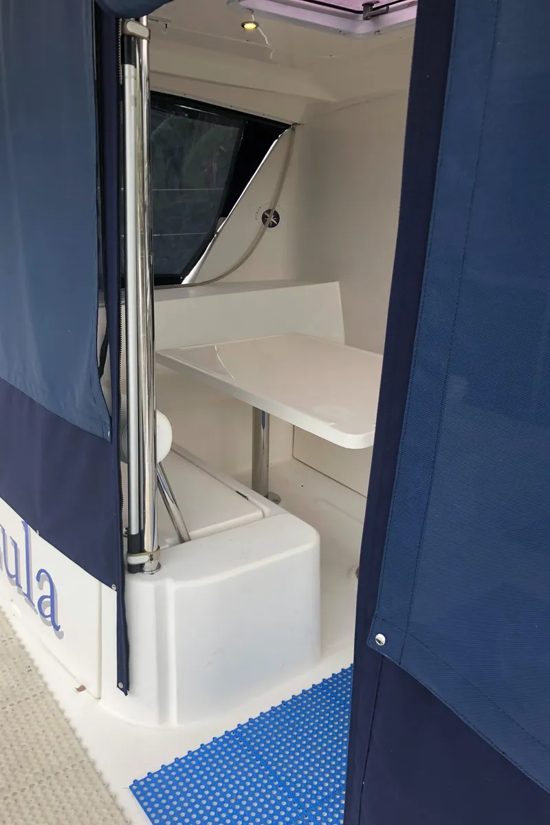 Slide: The Image of Interior view of 2013 Leopard 39 Owner's Version yacht with table and seating area. - 12