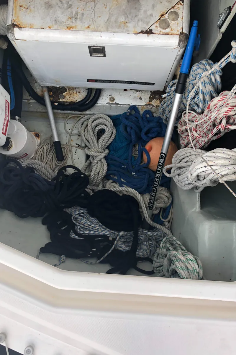 Slide: The Image of Storage compartment with ropes and equipment on a 2013 Leopard 39 Owner's Version boat. - 13