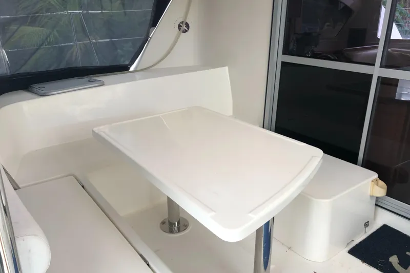 Slide: The Image of 2013 Leopard 39 Owner's Version yacht interior with sleek white table and seating area. - 17