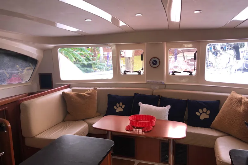 Slide: The Image of Interior of 2013 Leopard 39 Owner's Version catamaran with cozy seating and decorative pillows. - 19