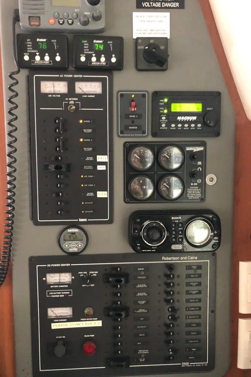 Slide: The Image of Control panel of a 2013 Leopard 39 Owner's Version catamaran with various switches and gauges. - 23