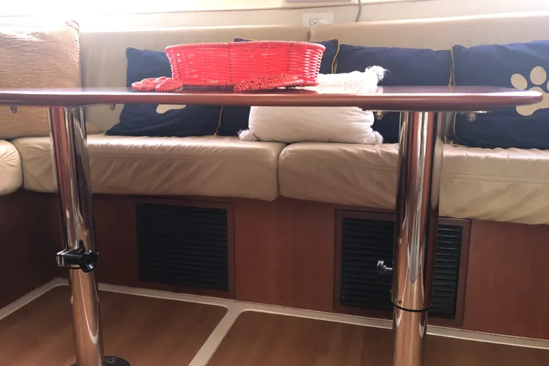 Slide: The Image of Interior of 2013 Leopard 39 yacht with table, cushions, and red basket. - 32