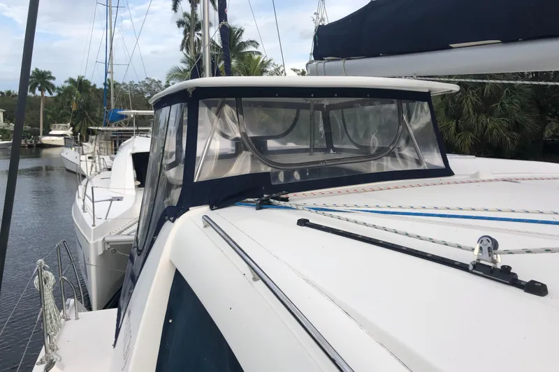 Slide: The Image of 2013 Leopard 39 Owner's Version catamaran docked, featuring sleek design and spacious deck. - 4