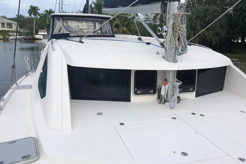 Slide: The Image of 2013 Leopard 39 Owner's Version catamaran docked, showcasing deck and rigging. - 5
