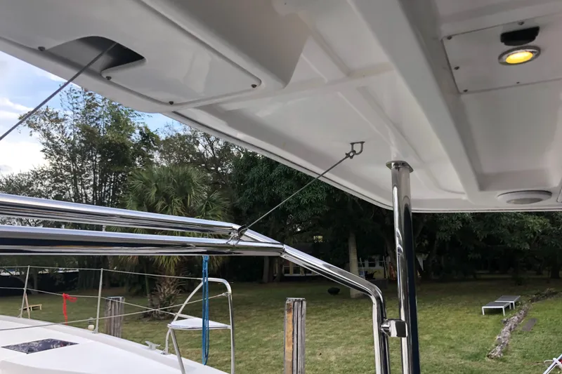 Slide: The Image of 2013 Leopard 39 Owner's Version catamaran deck with stainless steel railings and lush greenery background. - 9