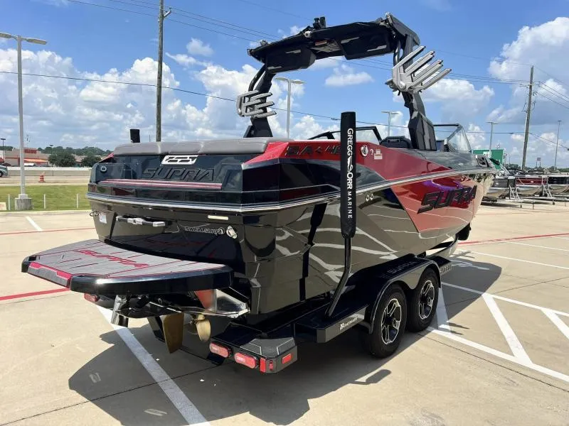 Slide: The Image of 2024 Supra SA 400 boat in black and red, parked on a trailer. - 5