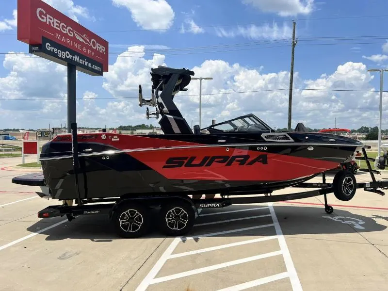 Slide: The Image of 2024 Supra SA 400 boat on trailer at Gregg Orr Marine & RV dealership. - 6