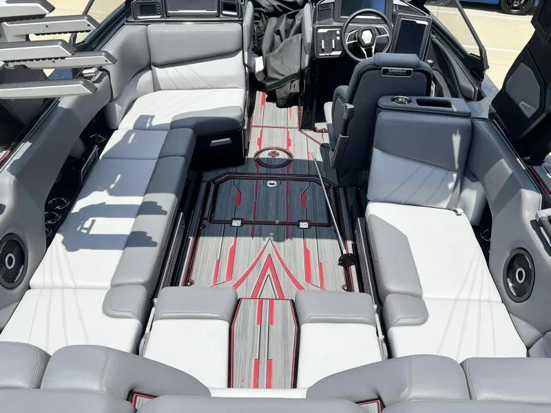 Slide: The Image of 2024 Supra SA 400 boat interior with gray and red seating and modern dashboard. - 8