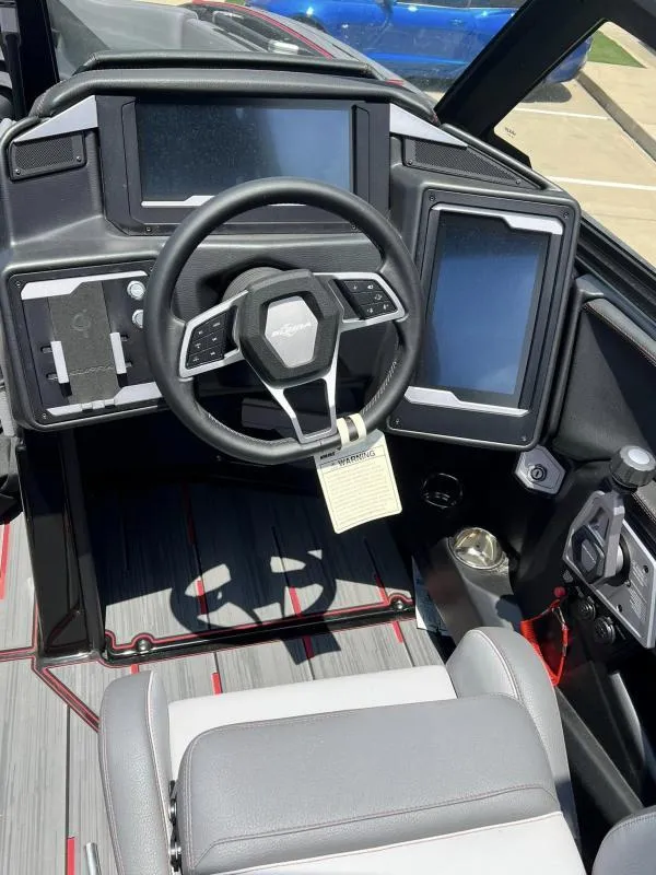 Slide: The Image of 2024 Supra SA 400 boat dashboard with steering wheel and digital displays. - 9