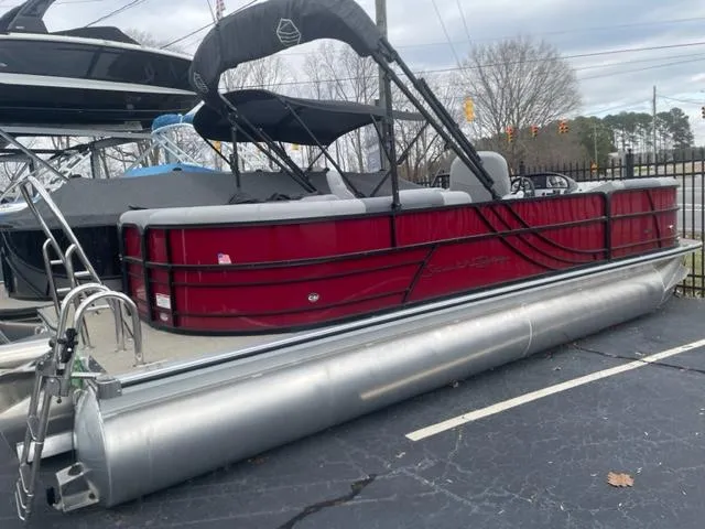 Slide: The Image of 2023 South Bay 224 RS 3.0 pontoon boat with red exterior on display. - 0