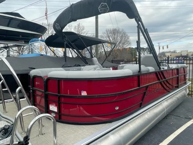 Slide: The Image of 2023 South Bay 224 RS 3.0 pontoon boat with red exterior and black canopy. - 2