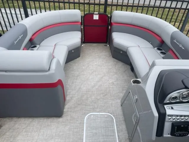 Slide: The Image of 2023 South Bay 224 RS 3.0 pontoon boat interior with gray and red seating. - 4