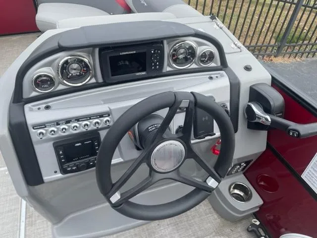 Slide: The Image of 2023 South Bay 224 RS 3.0 boat dashboard with steering wheel and control panel. - 5