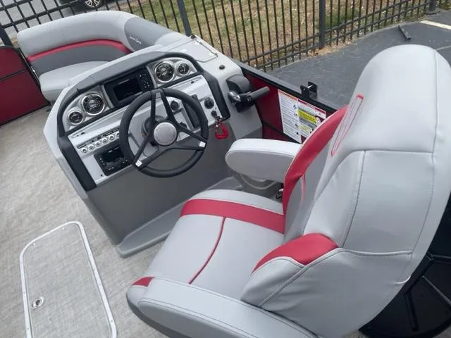 Slide: The Image of 2023 South Bay 224 RS 3.0 boat interior with steering wheel and seating. - 7