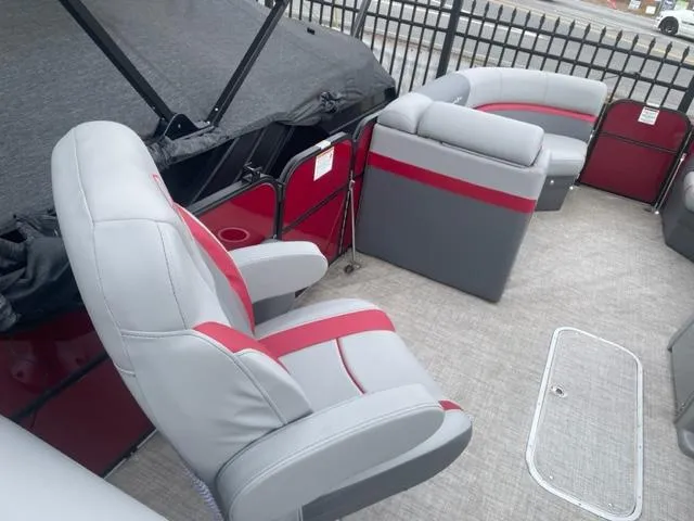 Slide: The Image of 2023 South Bay 224 RS 3.0 pontoon boat interior with gray and red seating. - 8