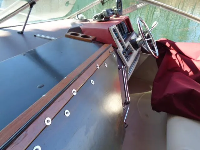 Slide: The Image of Interior cockpit of a 1986 Sea Ray 250 Sundancer boat with steering wheel and control panel. - 19