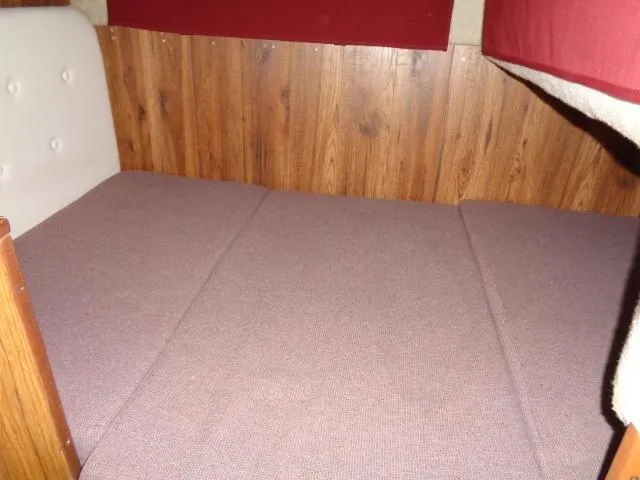 Slide: The Image of Interior cabin bed of a 1986 Sea Ray 250 Sundancer boat. - 7
