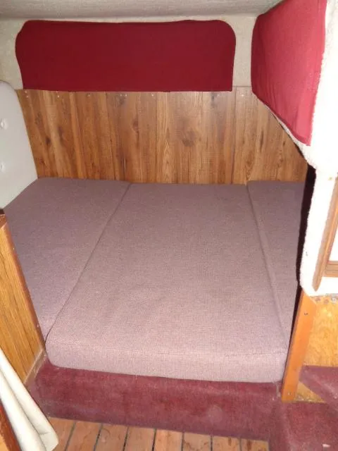 Slide: The Image of Interior cabin of a 1986 Sea Ray 250 Sundancer with a cozy bed. - 8