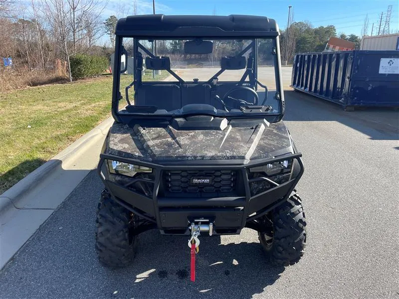 Slide: The Image of 2024 Tracker Off Road 800SX LE Camo utility vehicle on pavement. - 3