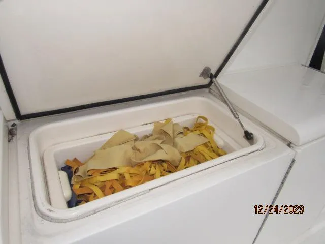 Slide: The Image of Storage compartment on a 2001 Ocean Yachts Super Sport boat with yellow straps. - 14