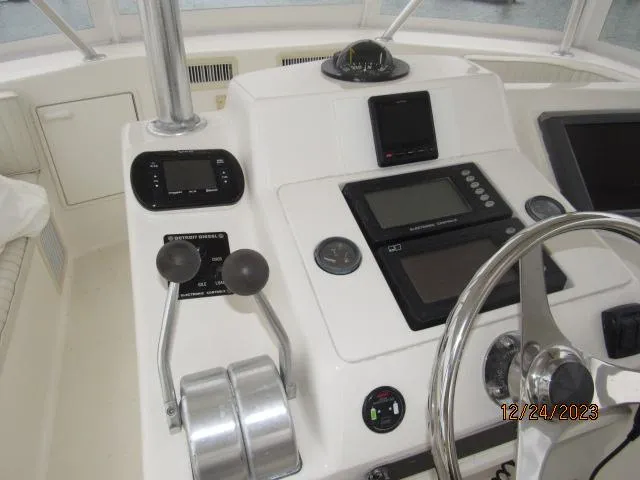 Slide: The Image of 2001 Ocean Yachts Super Sport boat dashboard with navigation controls and steering wheel. - 19