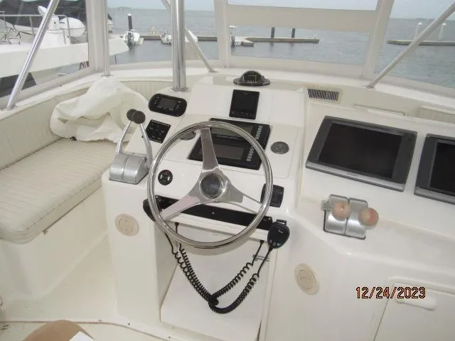 Slide: The Image of 2001 Ocean Yachts Super Sport helm with steering wheel and navigation equipment. - 21