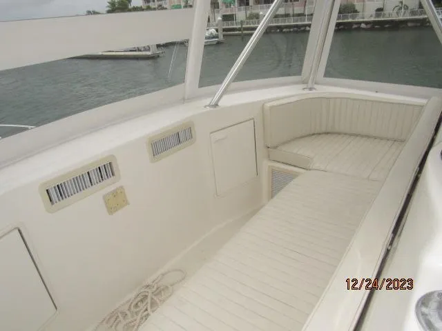 Slide: The Image of 2001 Ocean Yachts Super Sport boat interior with white seating and harbor view. - 22