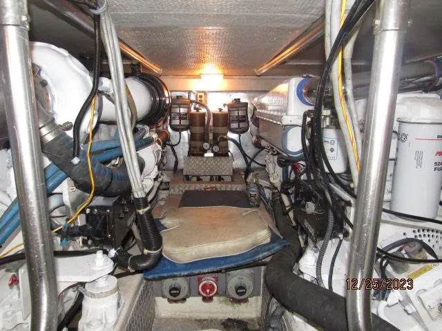 Slide: The Image of Engine room of a 2001 Ocean Yachts Super Sport boat with various mechanical components. - 23