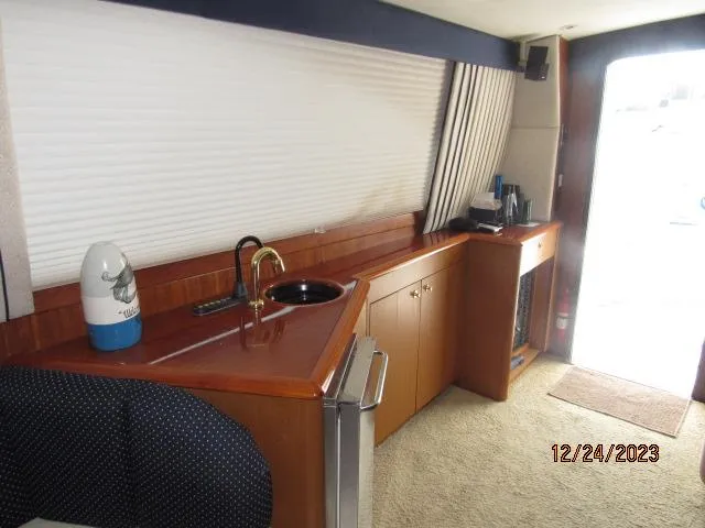 Slide: The Image of Interior of 2001 Ocean Yachts Super Sport with kitchenette and seating area. - 4
