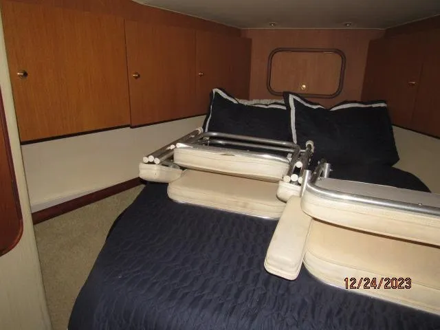 Slide: The Image of 2001 Ocean Yachts Super Sport cabin with bed and storage cabinets. - 9