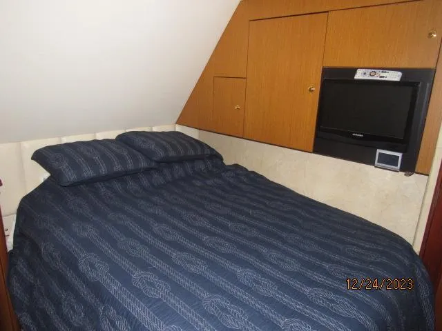 Slide: The Image of 2001 Ocean Yachts Super Sport bedroom with TV and storage cabinets. - 7