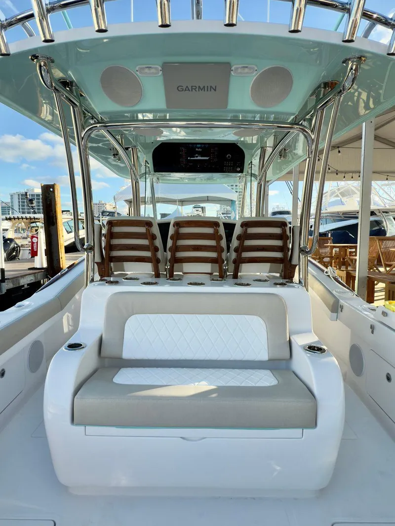 Slide: The Image of 2025 Mag Bay 38 CC boat interior with seating and Garmin electronics. - 21