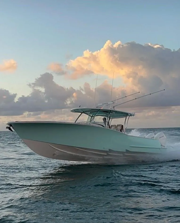 Slide: The Image of 2025 Mag Bay 38 CC boat cruising on ocean at sunset. - 4