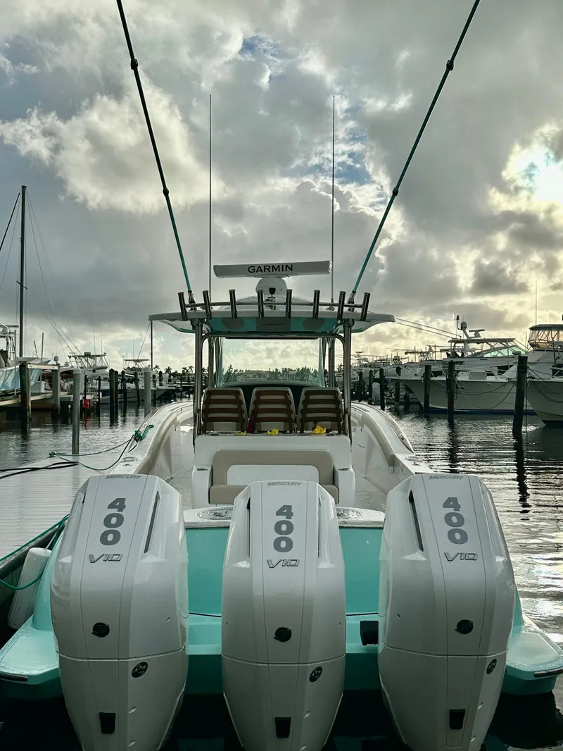 Slide: The Image of 2025 Mag Bay 38 CC boat with triple 400 V12 engines docked at marina. - 6