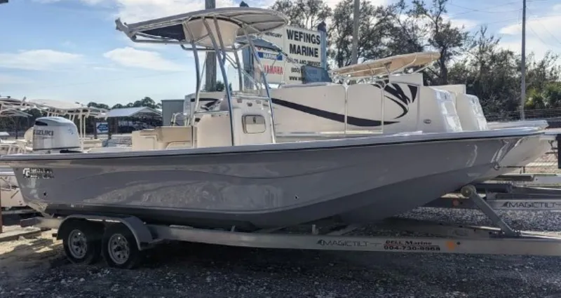 Slide: The Image of 2022 Carolina Skiff 23 LS boat on a trailer at a marine dealership. - 0