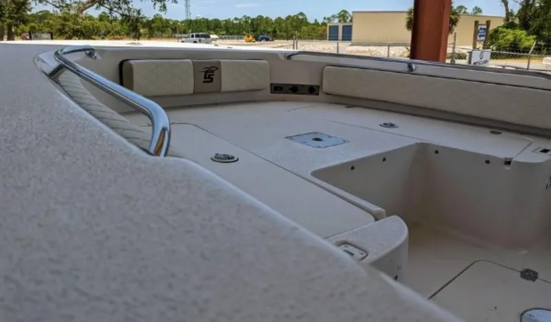 Slide: The Image of 2022 Carolina Skiff 24 Ultra Elite boat interior with cushioned seating and storage compartments. - 13
