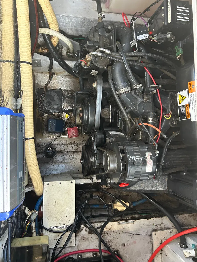 Slide: The Image of Engine compartment of a 2000 Four Winns 268 Vista boat with visible wiring and components. - 10