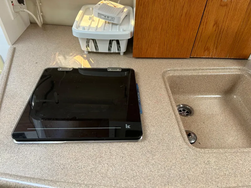 Slide: The Image of 2000 Four Winns 268 Vista boat kitchen sink and counter with stove. - 15