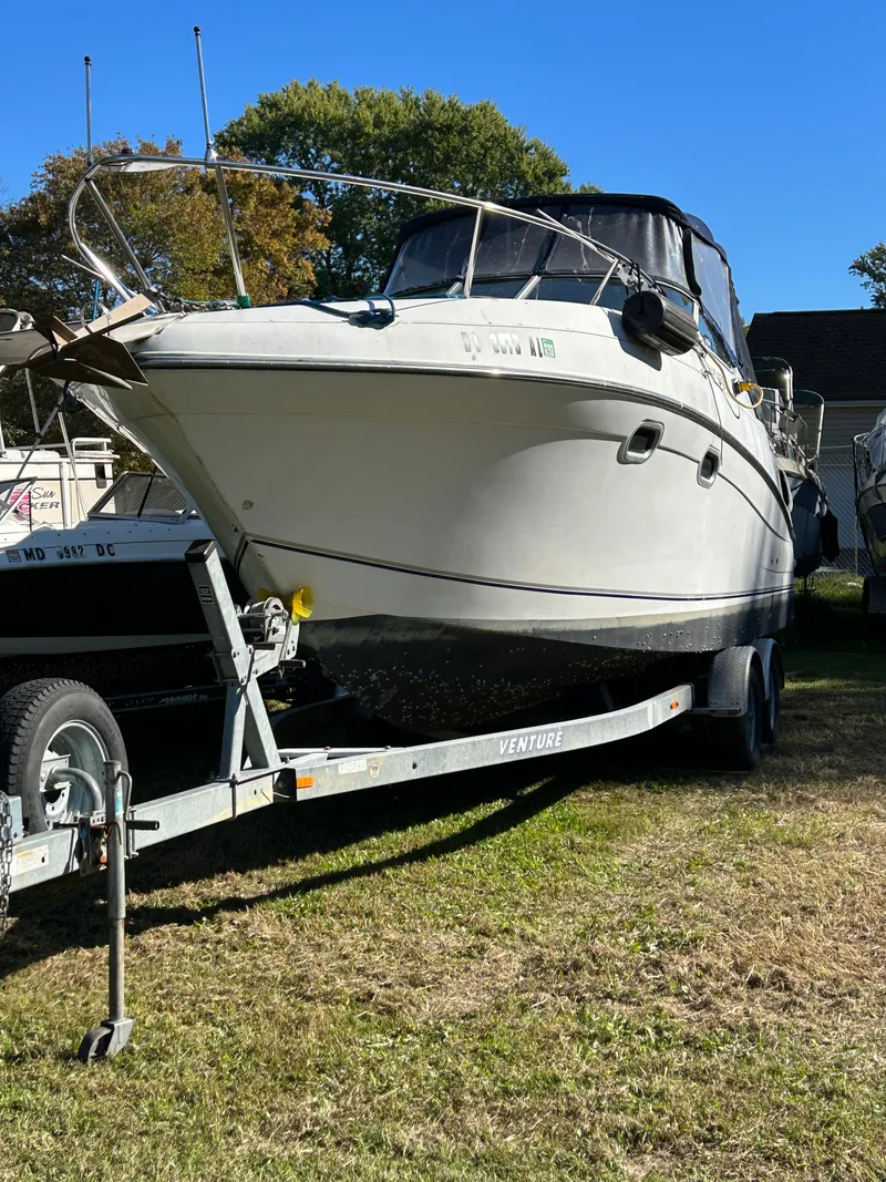 Slide: The Image of 2000 Four Winns 268 Vista boat on a trailer in a grassy area. - 4