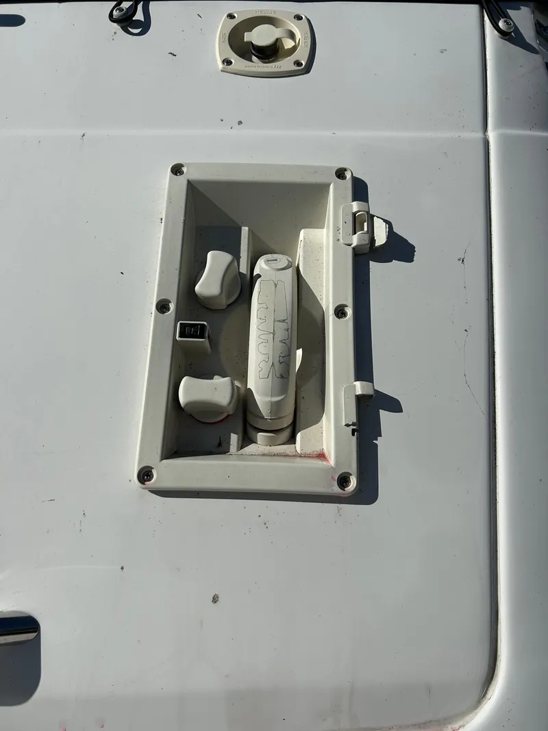 Slide: The Image of 2000 Four Winns 268 Vista boat control panel with switches and handle. - 5