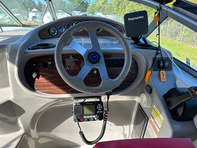 Slide: The Image of 2000 Four Winns 268 Vista boat helm with steering wheel and Raymarine electronics. - 8