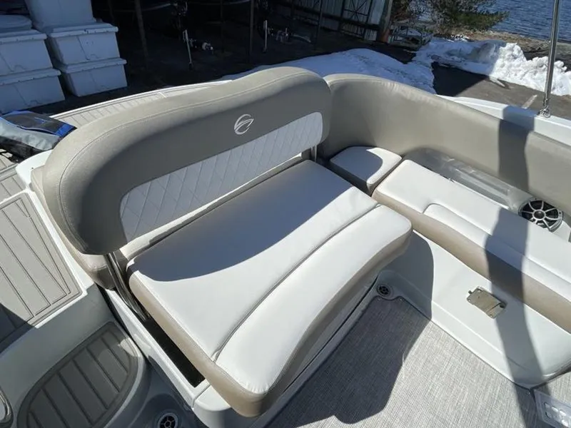 Slide: The Image of 2023 Crownline Eclipse E 235 boat interior seating in beige and white. - 11