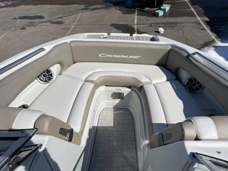 Slide: The Image of 2023 Crownline Eclipse E 235 boat interior with cushioned seating and speakers. - 13