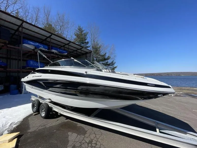 Slide: The Image of 2023 Crownline Eclipse E 235 boat on trailer by a lake. - 14