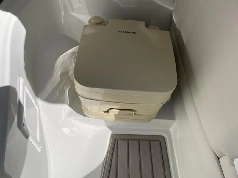 Slide: The Image of 2023 Crownline Eclipse E 235 boat portable toilet in the bathroom compartment. - 7
