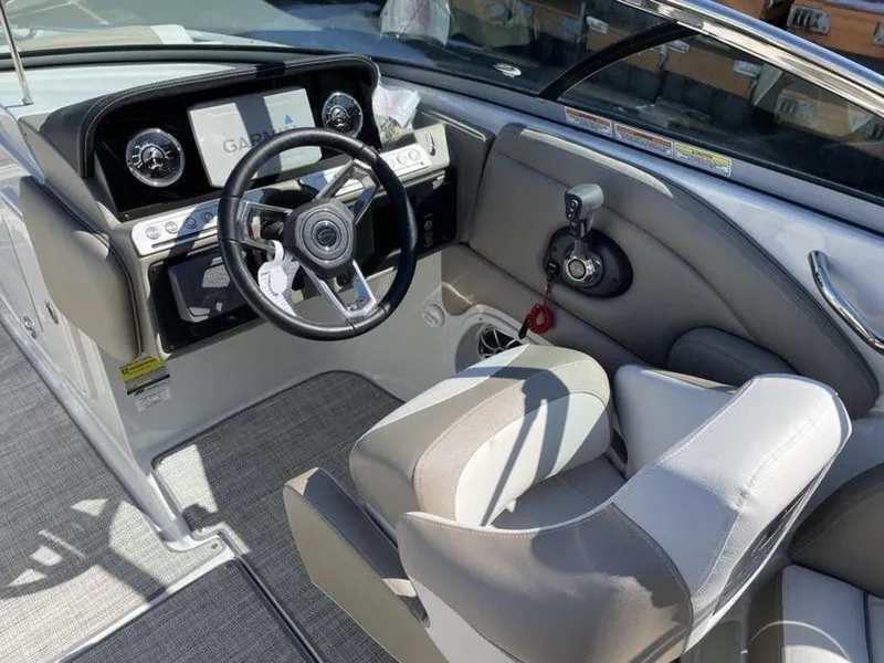 Slide: The Image of 2023 Crownline Eclipse E 235 boat cockpit with steering wheel and dashboard. - 8